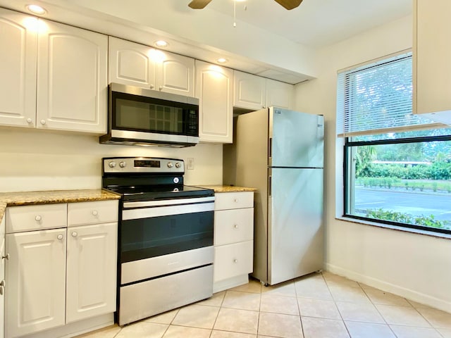 kitchen featuring white cabinets, stainless steel appliances, ceiling fan, and light tile patterned flooring