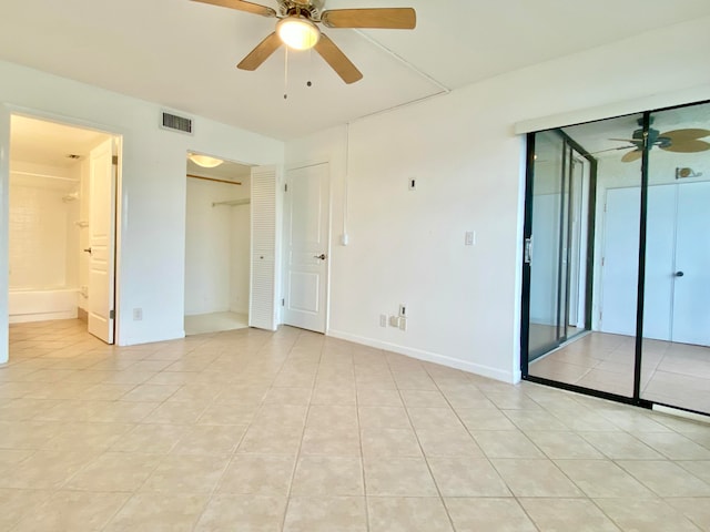 empty room featuring ceiling fan and light tile patterned flooring