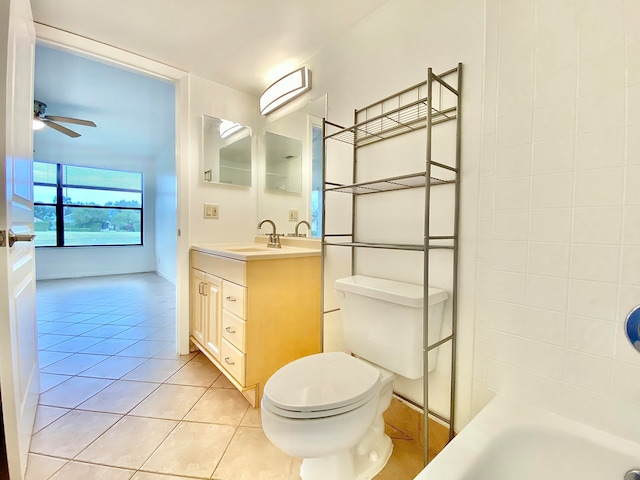 bathroom with a bathtub, vanity, ceiling fan, tile patterned flooring, and toilet