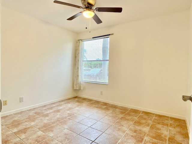 tiled empty room featuring ceiling fan