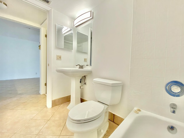 bathroom with toilet and tile patterned floors