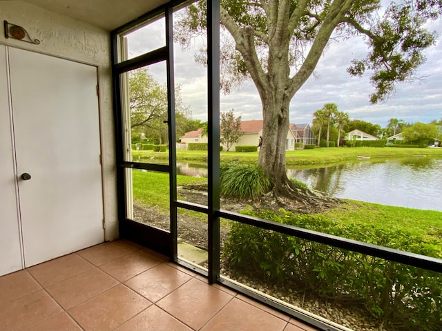 unfurnished sunroom featuring a water view and a wealth of natural light