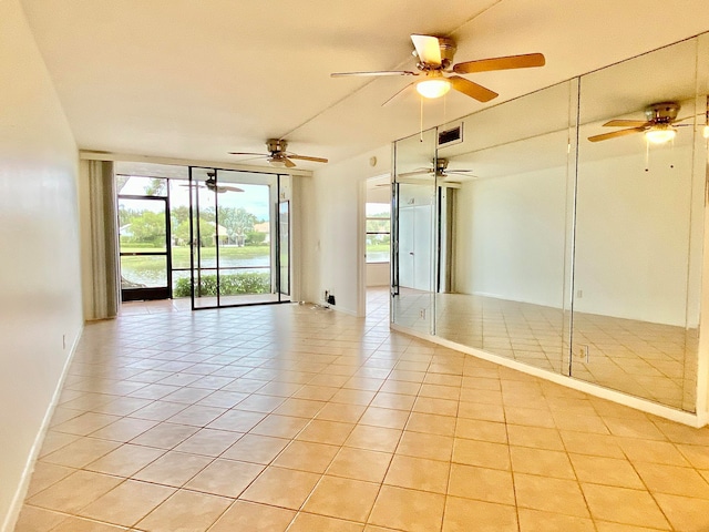 spare room featuring light tile patterned flooring