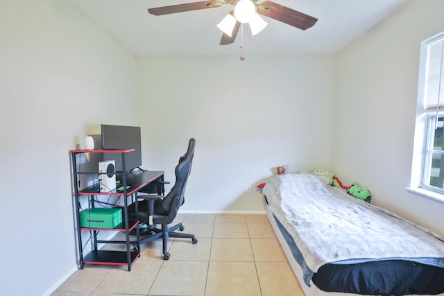 bedroom featuring ceiling fan, light tile patterned flooring, and multiple windows