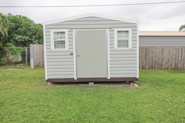 view of outbuilding featuring a lawn