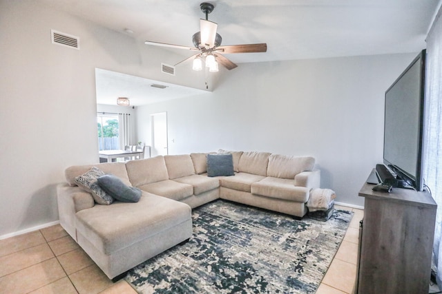 living room with ceiling fan, light tile patterned floors, and lofted ceiling