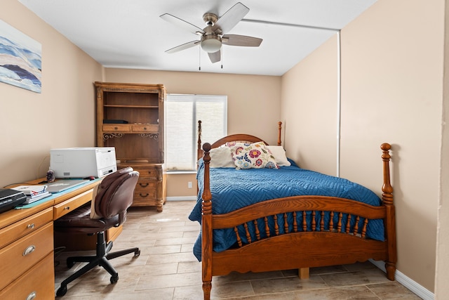 bedroom with a ceiling fan and baseboards