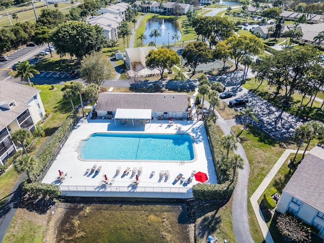 drone / aerial view featuring a residential view and a water view