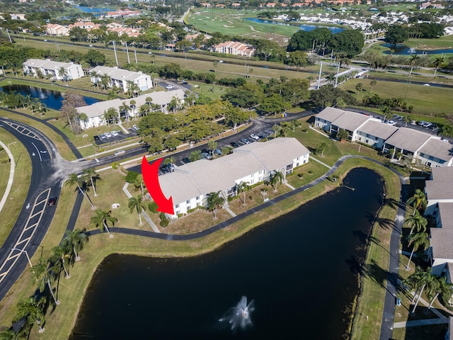 drone / aerial view featuring a residential view and a water view