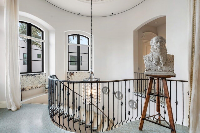 813 N Atlantic Dr, Lantana, FL 33462 - hall with an upstairs landing, arched walkways, and a chandelier