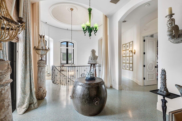 813 N Atlantic Dr, Lantana, FL 33462 - corridor featuring arched walkways, speckled floor, baseboards, an upstairs landing, and a high ceiling