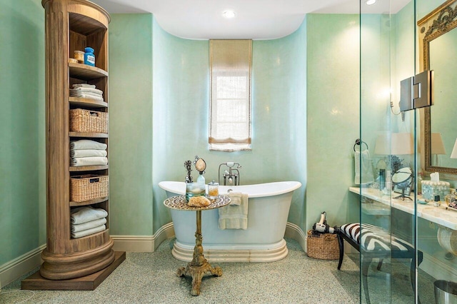 813 N Atlantic Dr, Lantana, FL 33462 - full bath with speckled floor, a freestanding tub, a stall shower, and baseboards