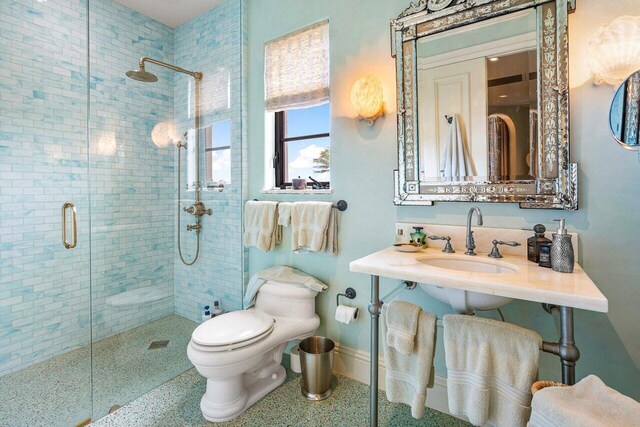 813 N Atlantic Dr, Lantana, FL 33462 - full bathroom with a shower stall, a sink, toilet, speckle patterned floor, and baseboards