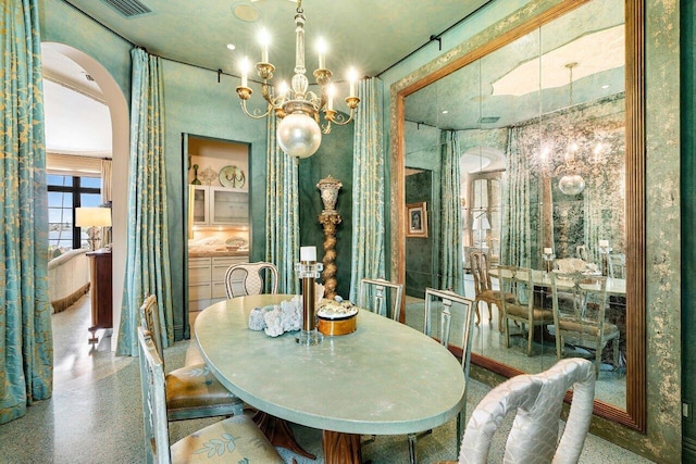 813 N Atlantic Dr, Lantana, FL 33462 - dining room featuring arched walkways, speckle patterned floor, and a chandelier