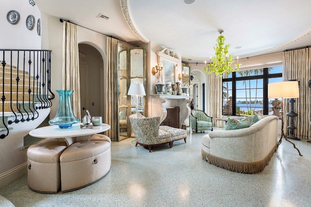 813 N Atlantic Dr, Lantana, FL 33462 - living area with arched walkways, speckle patterned floor, and a chandelier