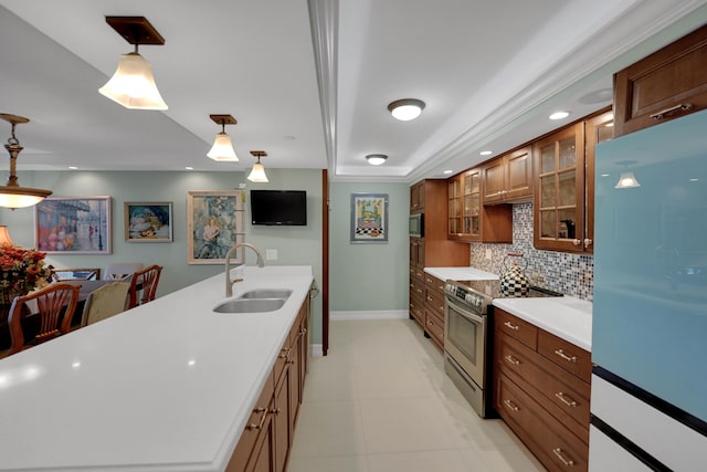 kitchen featuring pendant lighting, sink, decorative backsplash, ornamental molding, and appliances with stainless steel finishes