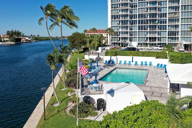 view of pool with a water view and a patio