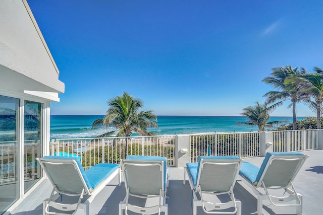 balcony with a beach view and a water view