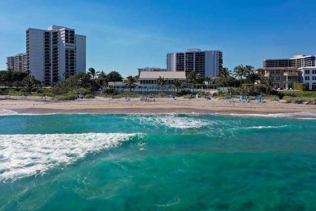 birds eye view of property featuring a water view and a beach view