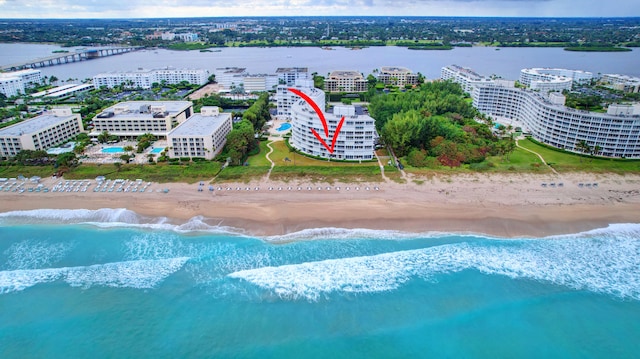 birds eye view of property with a water view and a view of the beach