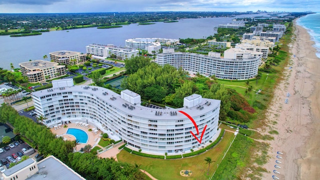 drone / aerial view featuring a water view and a beach view