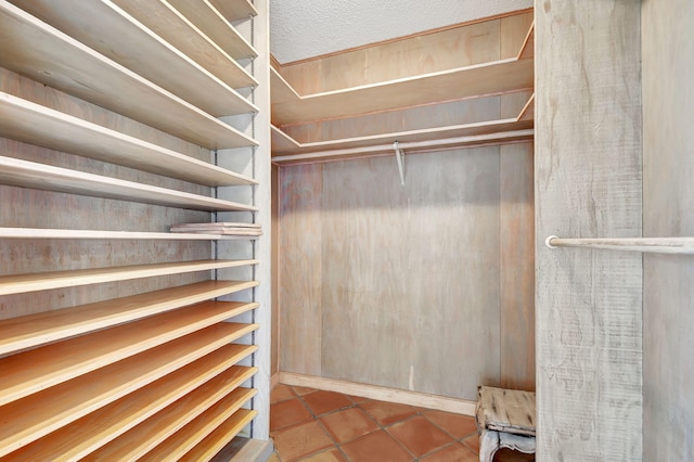 walk in closet with light tile patterned flooring