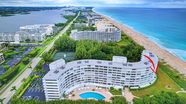 birds eye view of property with a water view and a view of the beach