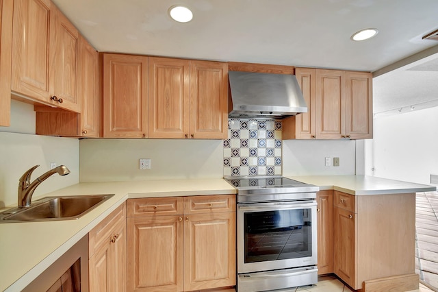 kitchen with stainless steel range with electric stovetop, sink, light brown cabinetry, range hood, and kitchen peninsula