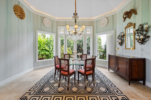 dining room with crown molding and a notable chandelier