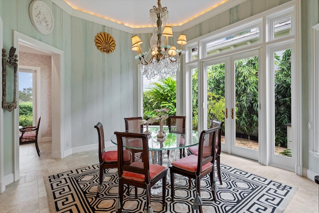 dining room with a notable chandelier and french doors