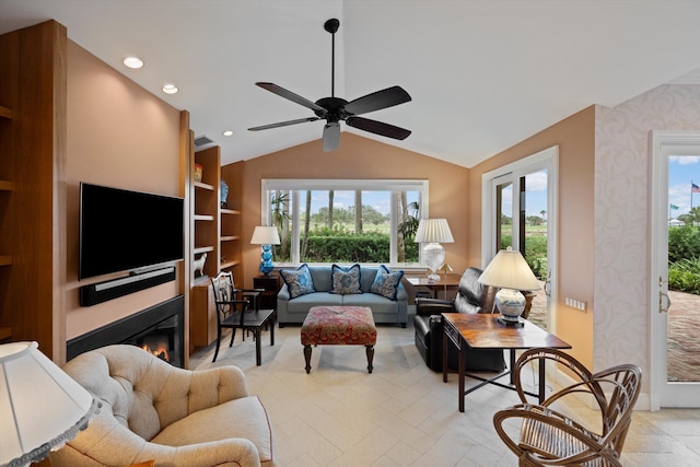 living room featuring ceiling fan and vaulted ceiling