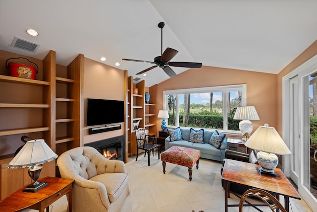 living room with ceiling fan and lofted ceiling