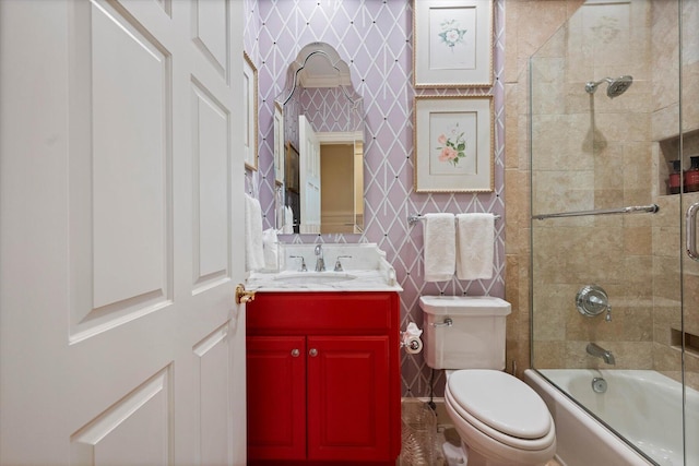 full bathroom featuring shower / bath combination with glass door, vanity, and toilet