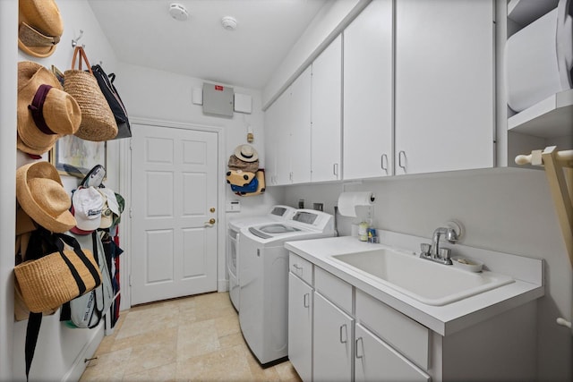 washroom featuring cabinets, washer and dryer, and sink