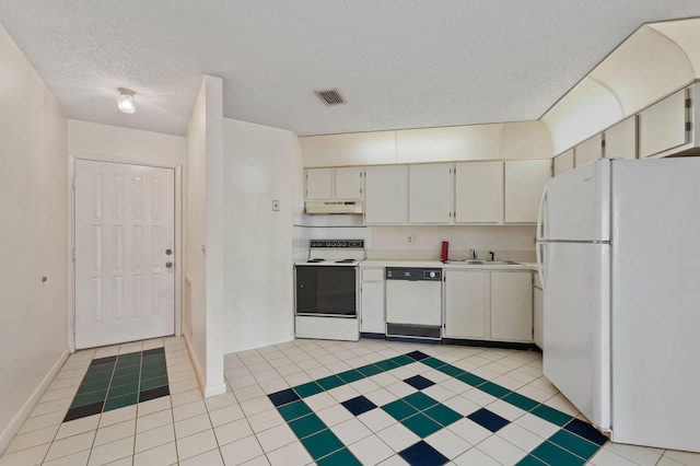 kitchen featuring white cabinetry, light tile patterned flooring, white appliances, and a textured ceiling