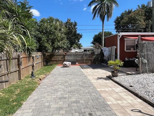 view of patio / terrace featuring a storage shed