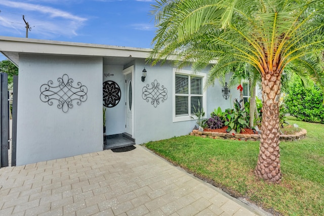 doorway to property featuring a yard