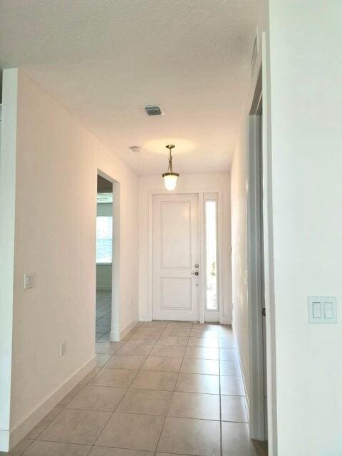 foyer featuring a healthy amount of sunlight and light tile patterned floors