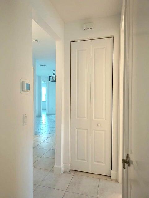 hall featuring light tile patterned floors