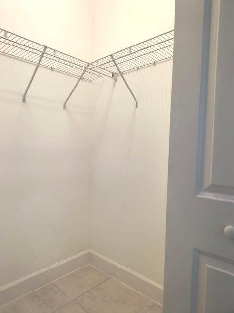 spacious closet with tile patterned floors