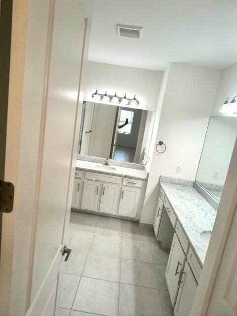 bathroom featuring tile patterned floors and vanity