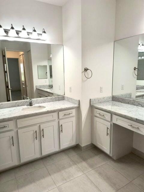 bathroom with tile patterned floors and vanity