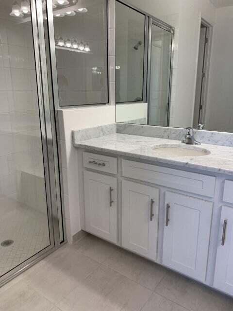 bathroom with vanity and an enclosed shower