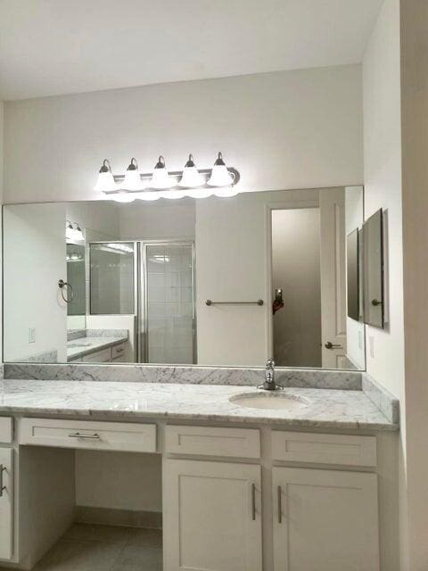 bathroom with vanity and walk in shower