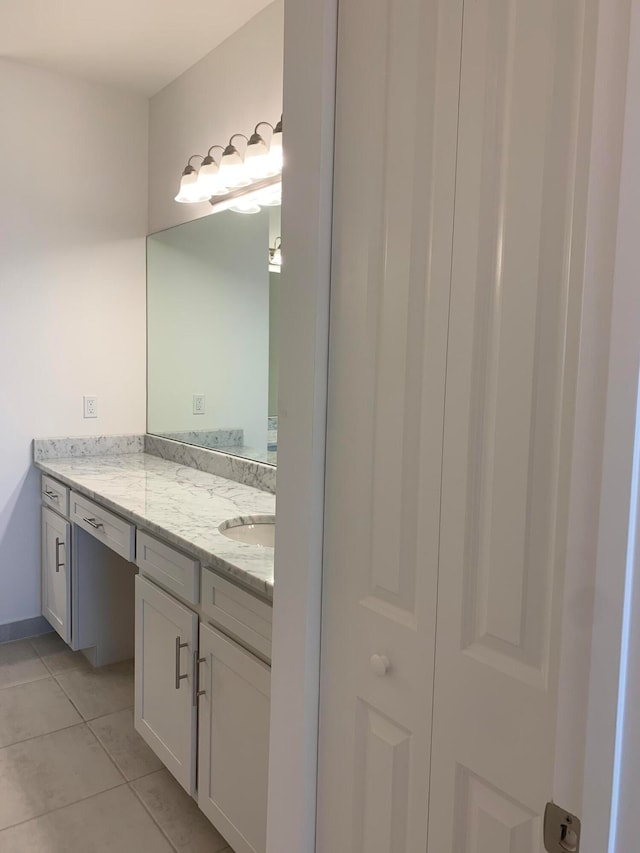 bathroom featuring tile patterned flooring and vanity