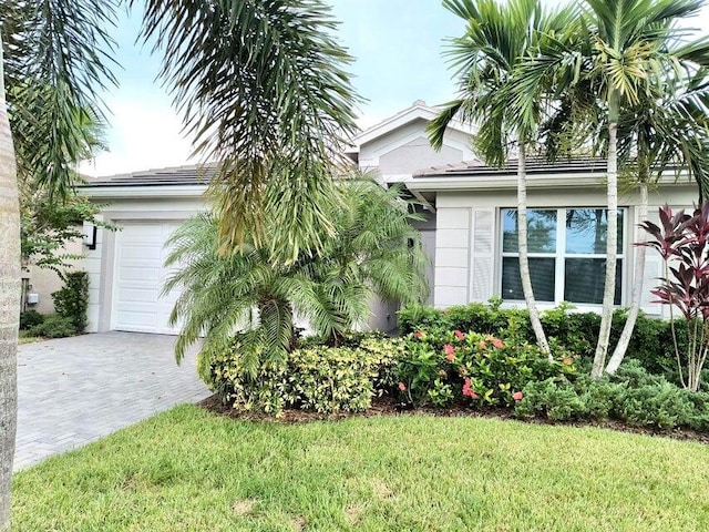 view of side of property featuring a garage and a yard