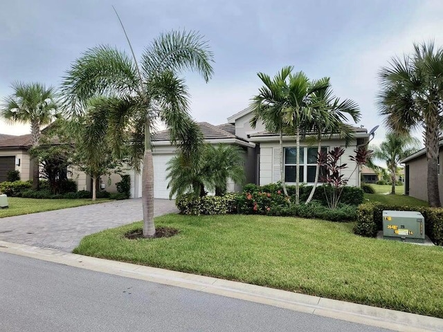 view of front of house with a garage and a front yard