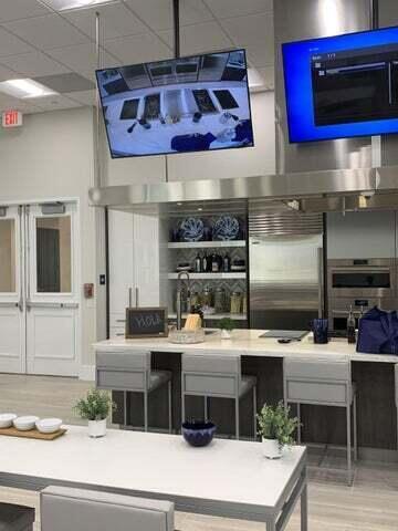 bar featuring hardwood / wood-style floors, a drop ceiling, and stainless steel built in refrigerator