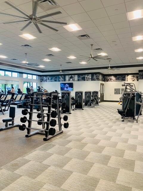 workout area featuring a paneled ceiling and ceiling fan