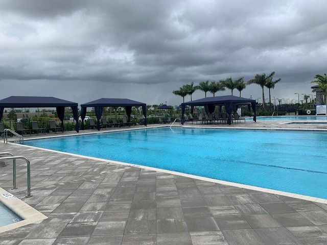 view of swimming pool featuring a gazebo and a patio area